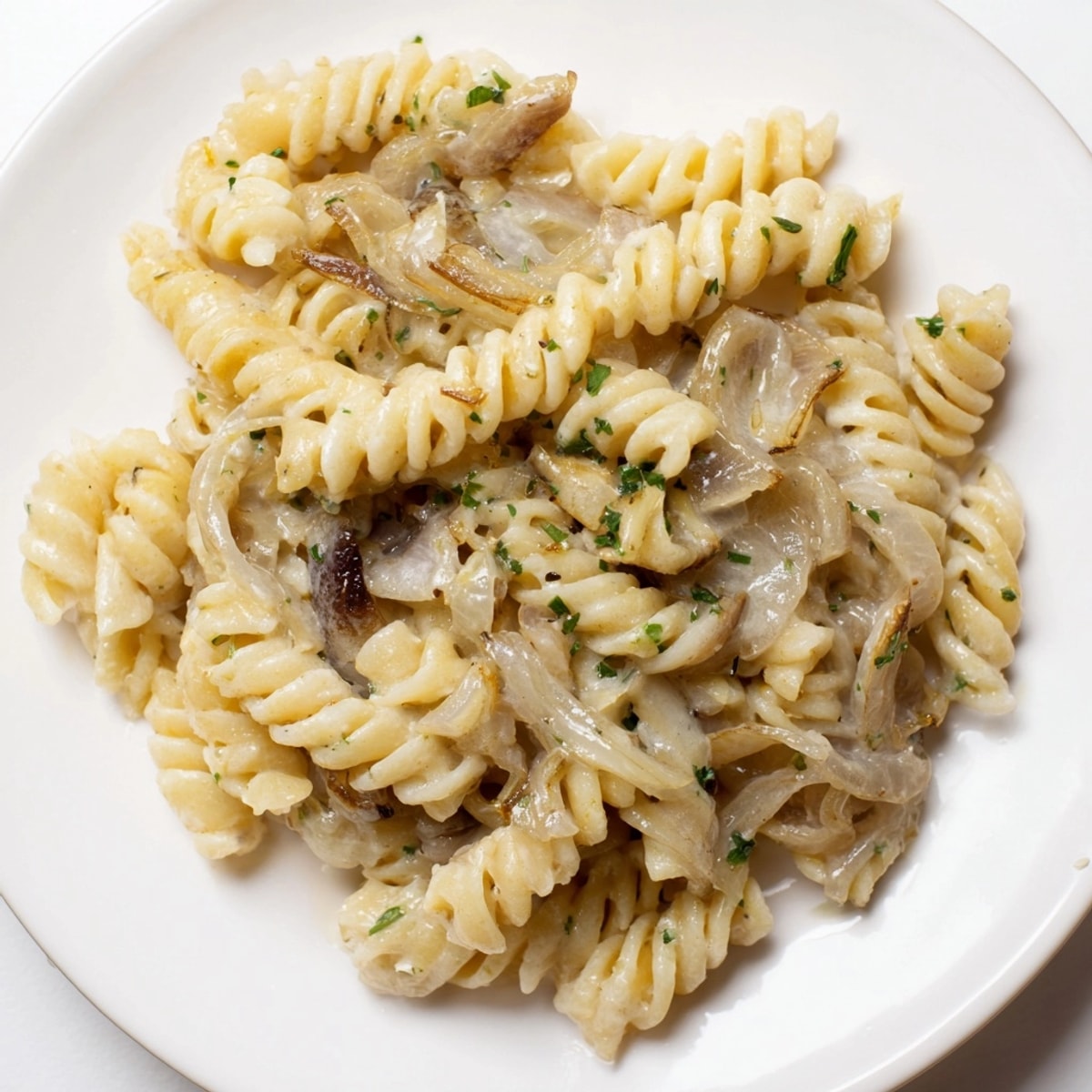 Creamy One-Pot French Onion Pasta sparkles with melted Gruyère, ready for a cozy dinner.