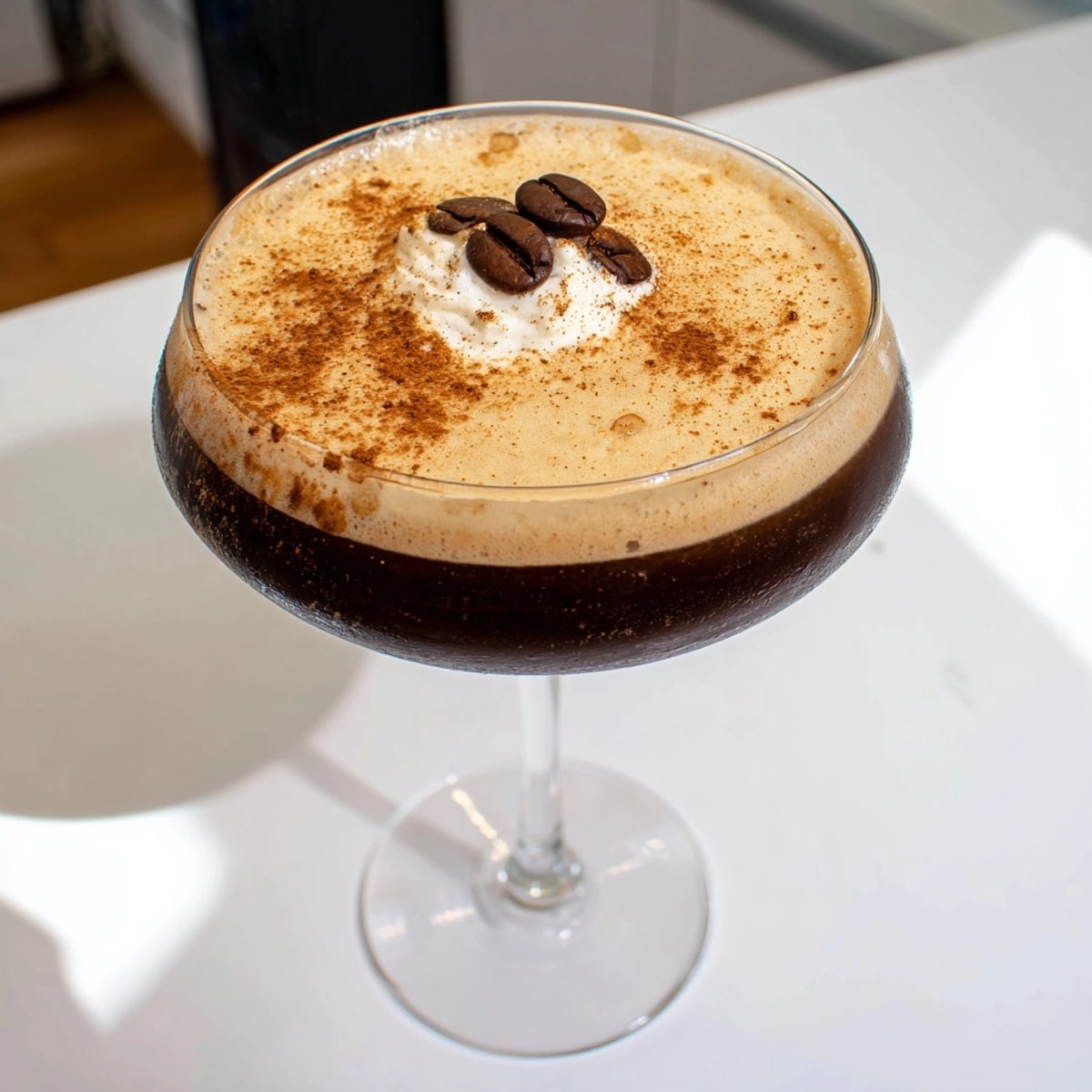 Frothy Pumpkin Spice Espresso Martini: Rich autumnal flavors swirled in a clear martini glass.