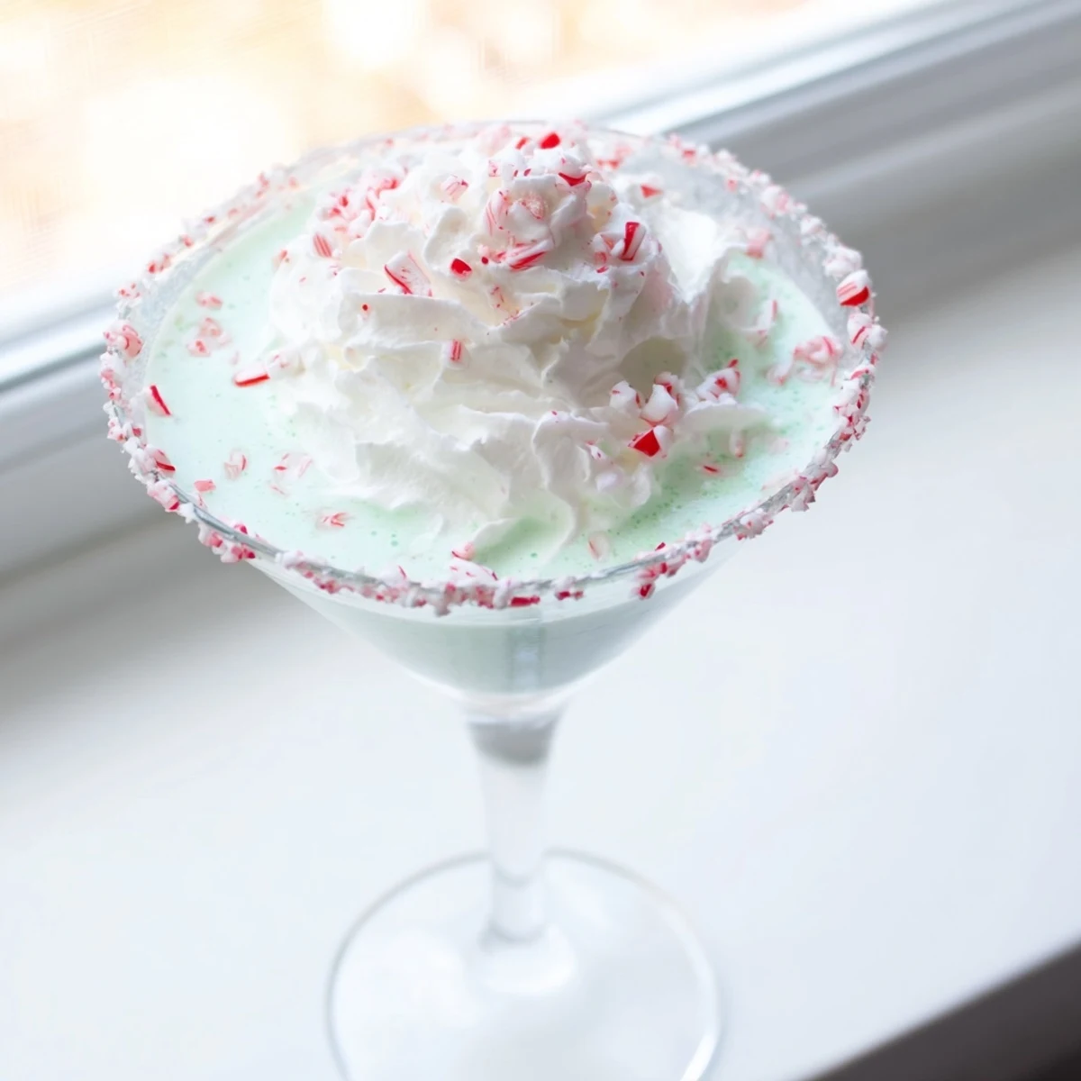 Enjoy a festive-looking Peppermint Twist: a holiday cocktail with refreshing peppermint notes.