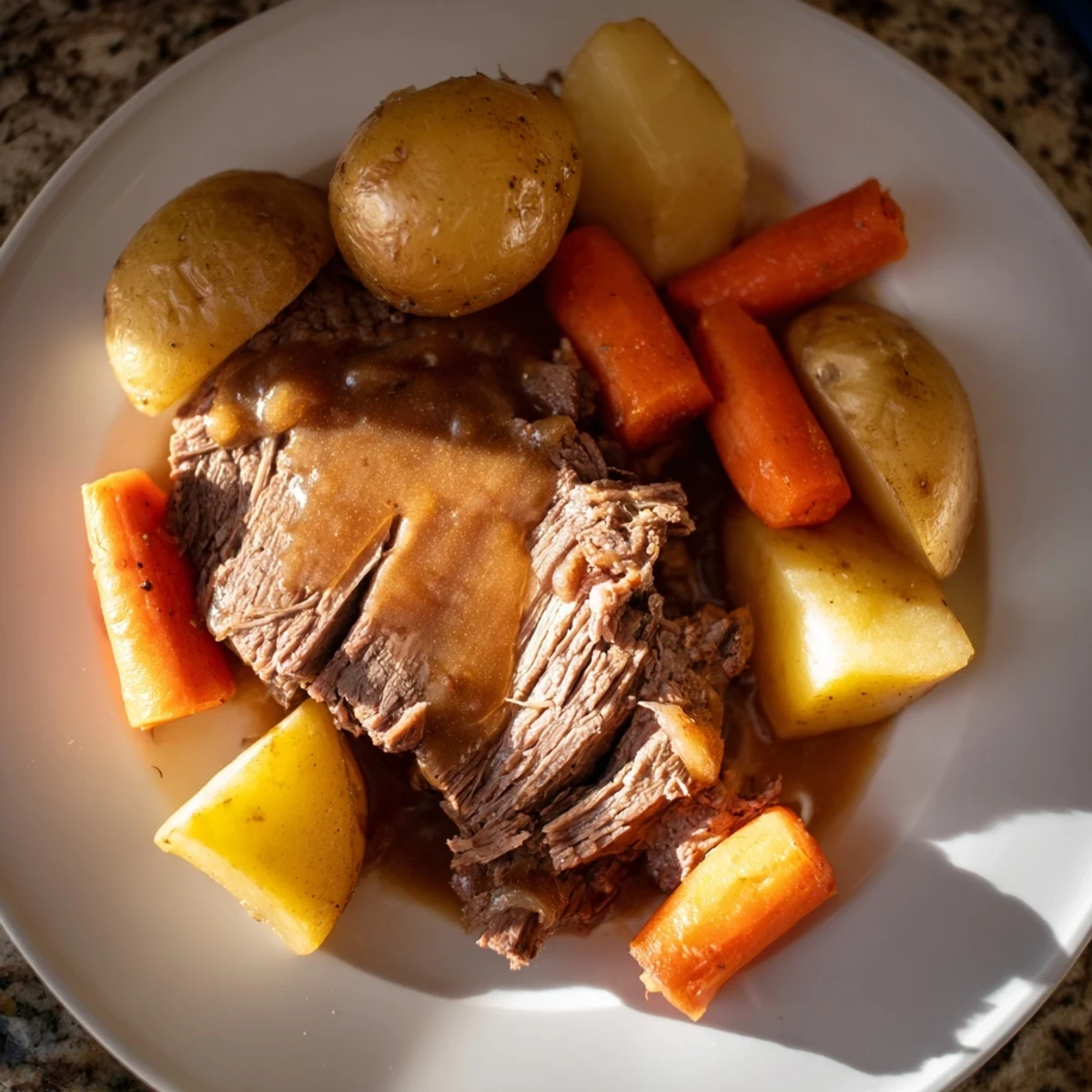 A steaming, close-up view of a classic beef pot roast showcasing fall-apart beef and vibrant carrots.