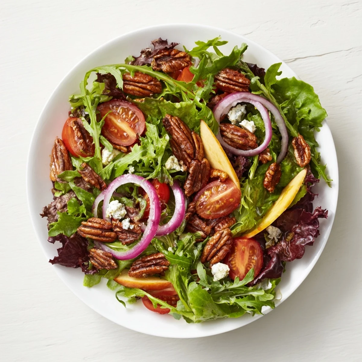 Vibrant Pecan Salad with toasted pecans, crisp greens, and creamy goat cheese, ready to enjoy.