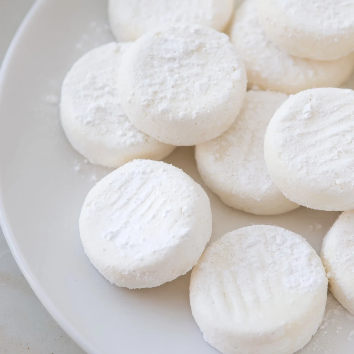 A close-up of beautifully swirled Peppermint Sweets candies, looking fresh and perfectly formed on the tray.