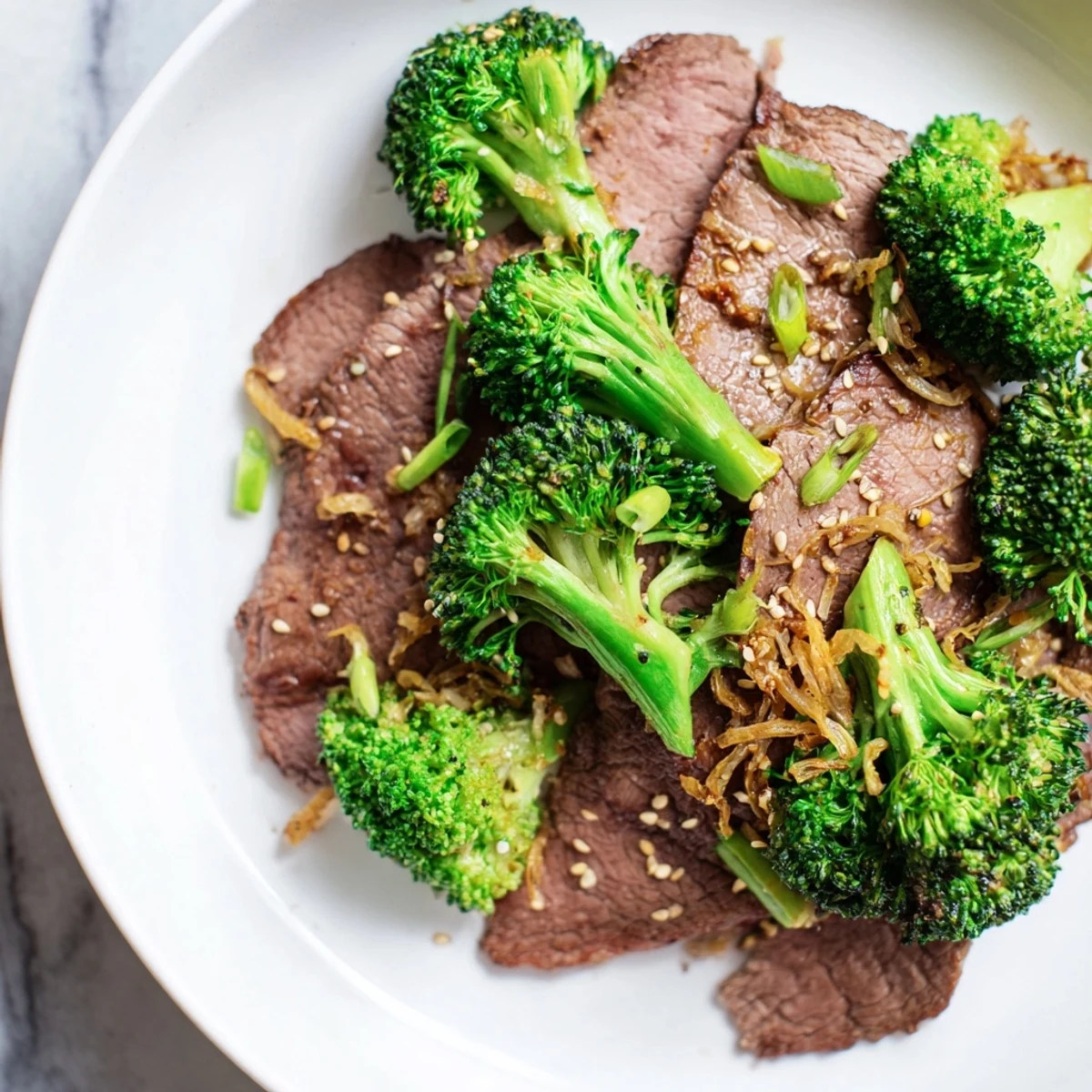 Sizzling beef strips and crisp broccoli florets coated in a glossy ginger sauce, highlighting the savory aromas of this Keto Friendly Beef and Broccoli Stir Fry.