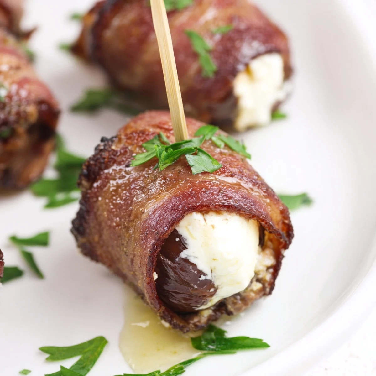 Air Fryer Crispy Beef Bacon Wrapped Dates, golden brown and sizzling, served warm as a savory gluten-free appetizer.