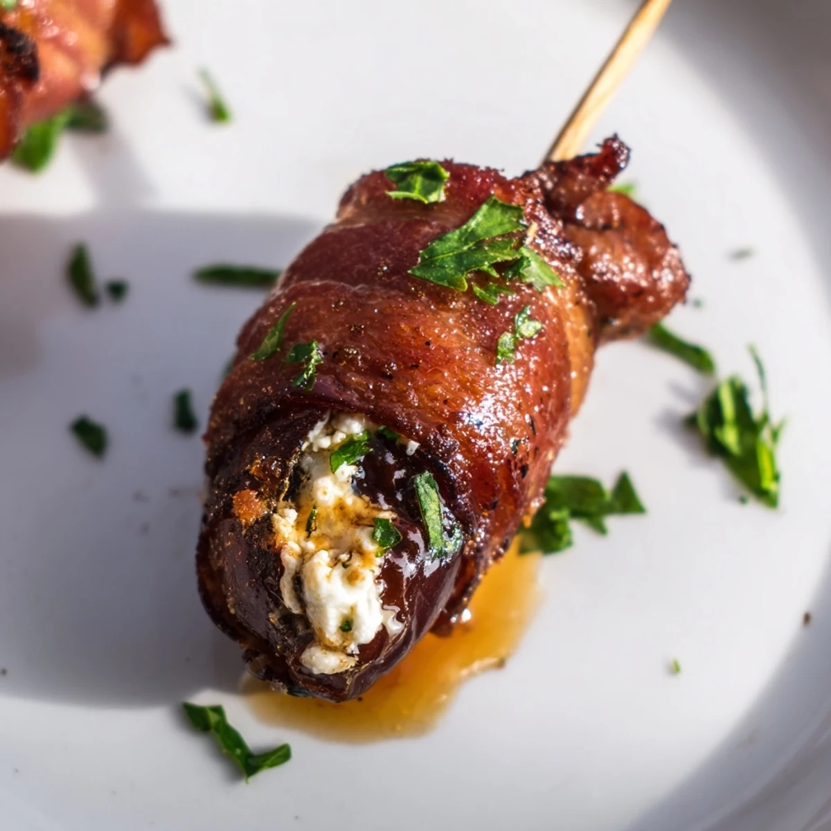 Stuffed Medjool dates filled with creamy goat cheese, wrapped in crispy beef bacon, and drizzled with sweet honey.