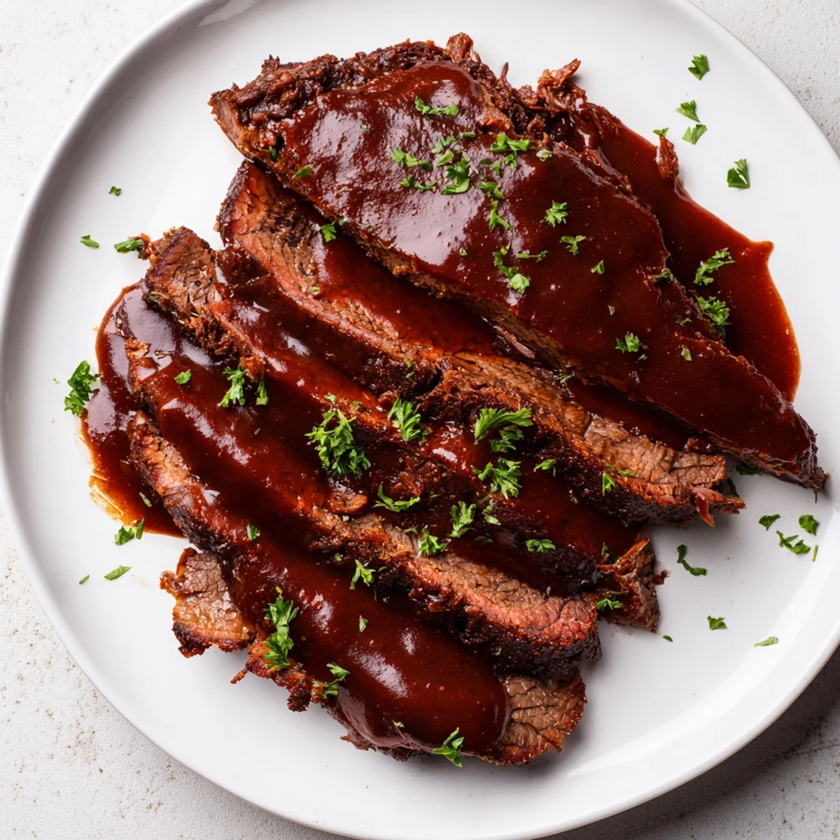 Juicy Slow Cooker Beef Brisket served with mashed potatoes and fresh parsley, drizzled with extra sauce.