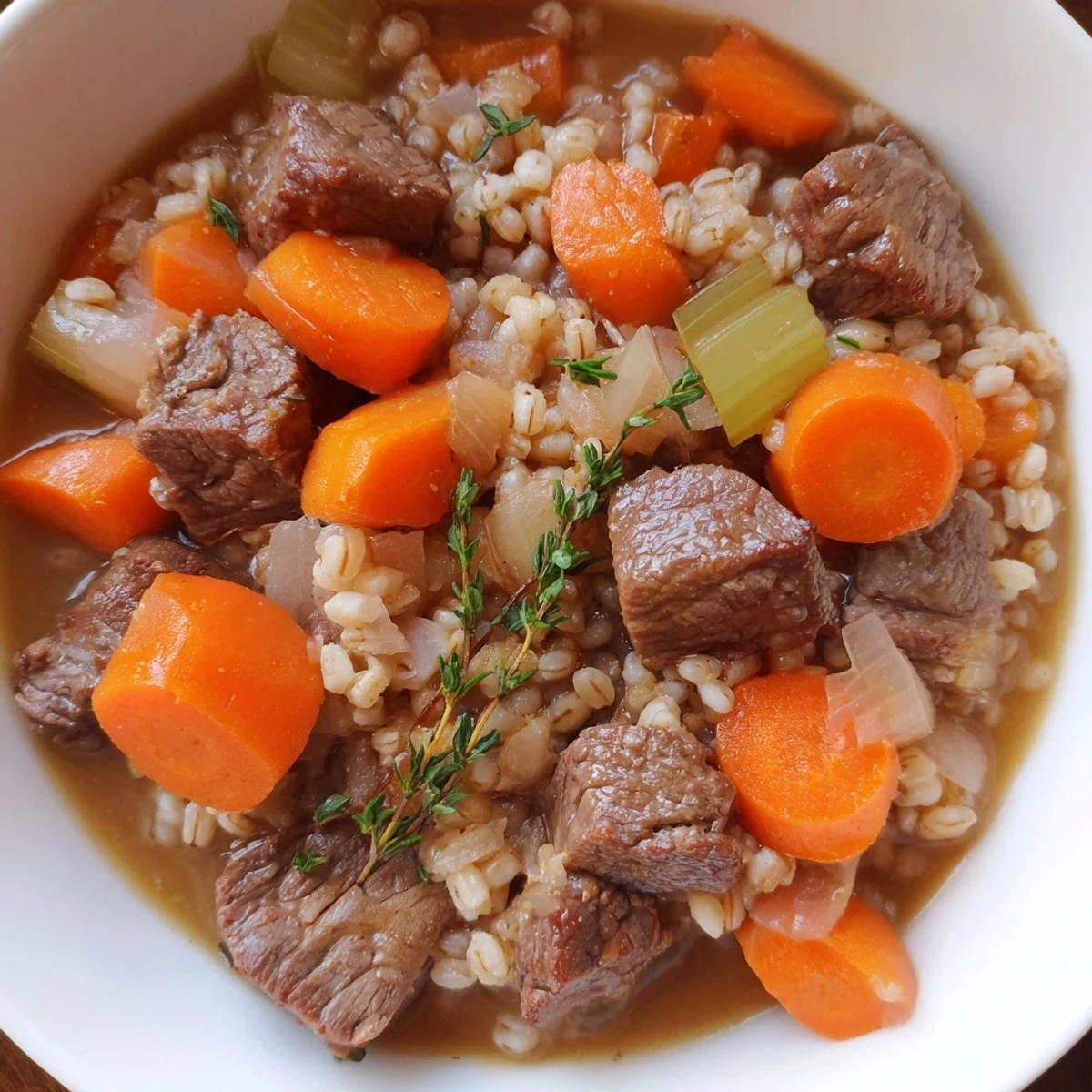 Close-up of Beef and Barley Stew with Thyme and Carrots, featuring juicy beef, soft barley, and sliced carrots.