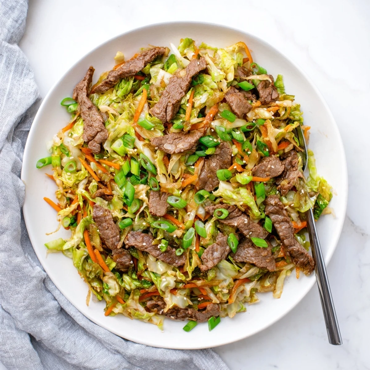 Keto Friendly Beef and Cabbage Stir Fry with tender beef strips and crisp cabbage in a savory sauce.