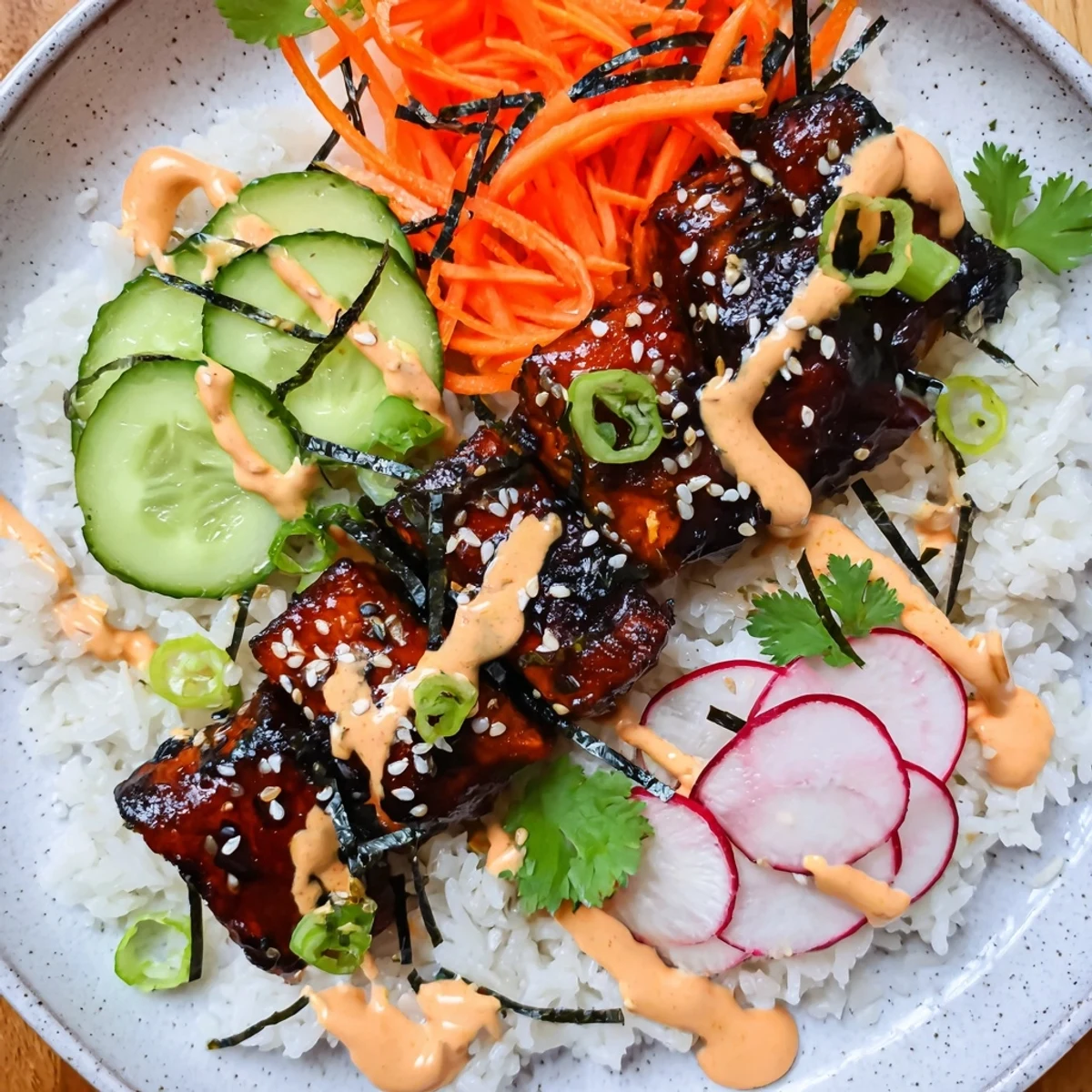 Flaky teriyaki salmon rests on fluffy jasmine rice with colorful pickled veggies in this Teriyaki Salmon Rice Taco Bowl.
