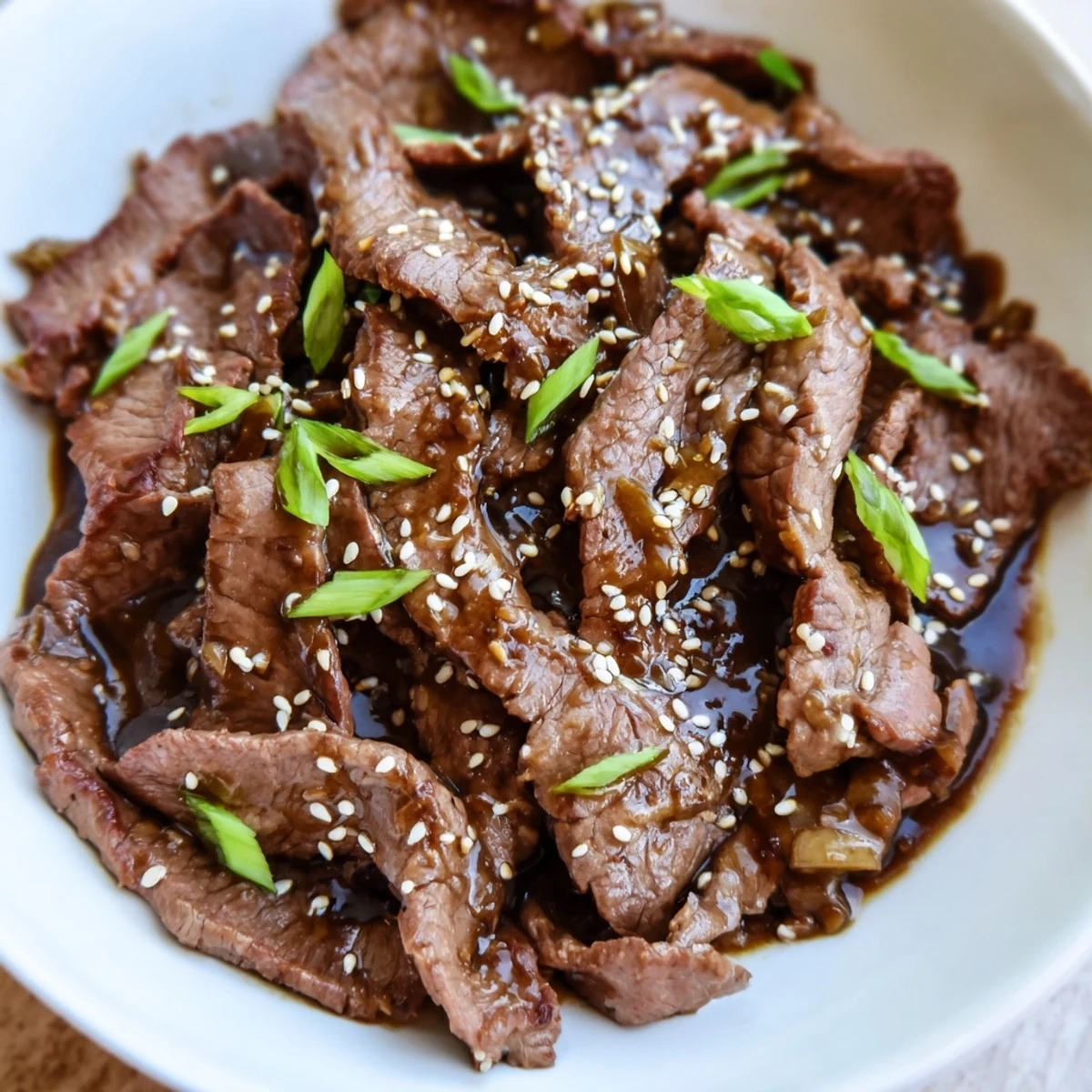 The final plated Ultimate Slow Cooker Mongolian Beef shows tender beef slices and a rich savory-sweet sauce.
