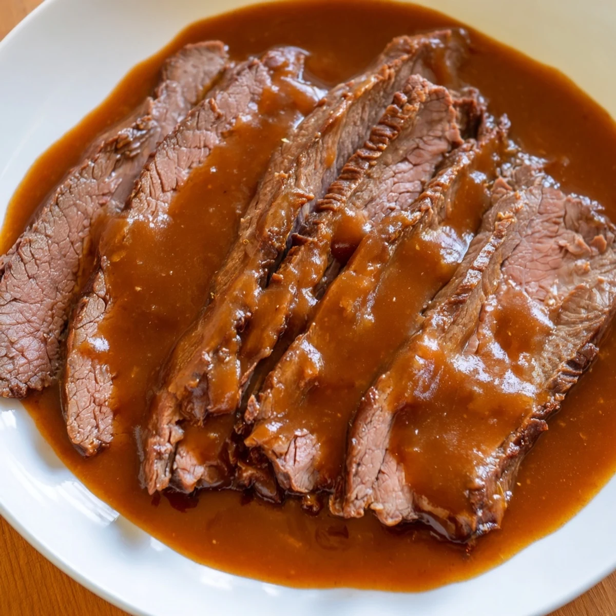 Tender beef strips from Ultimate Slow Cooker Mongolian Beef piled high next to broccoli and fluffy steamed rice.