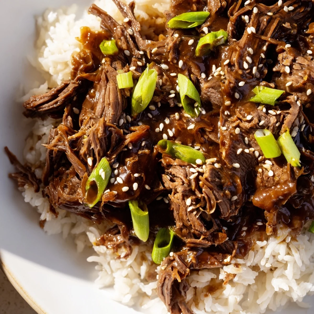 Savory Crock Pot Korean Beef served steaming hot from the crock pot with sesame seeds.