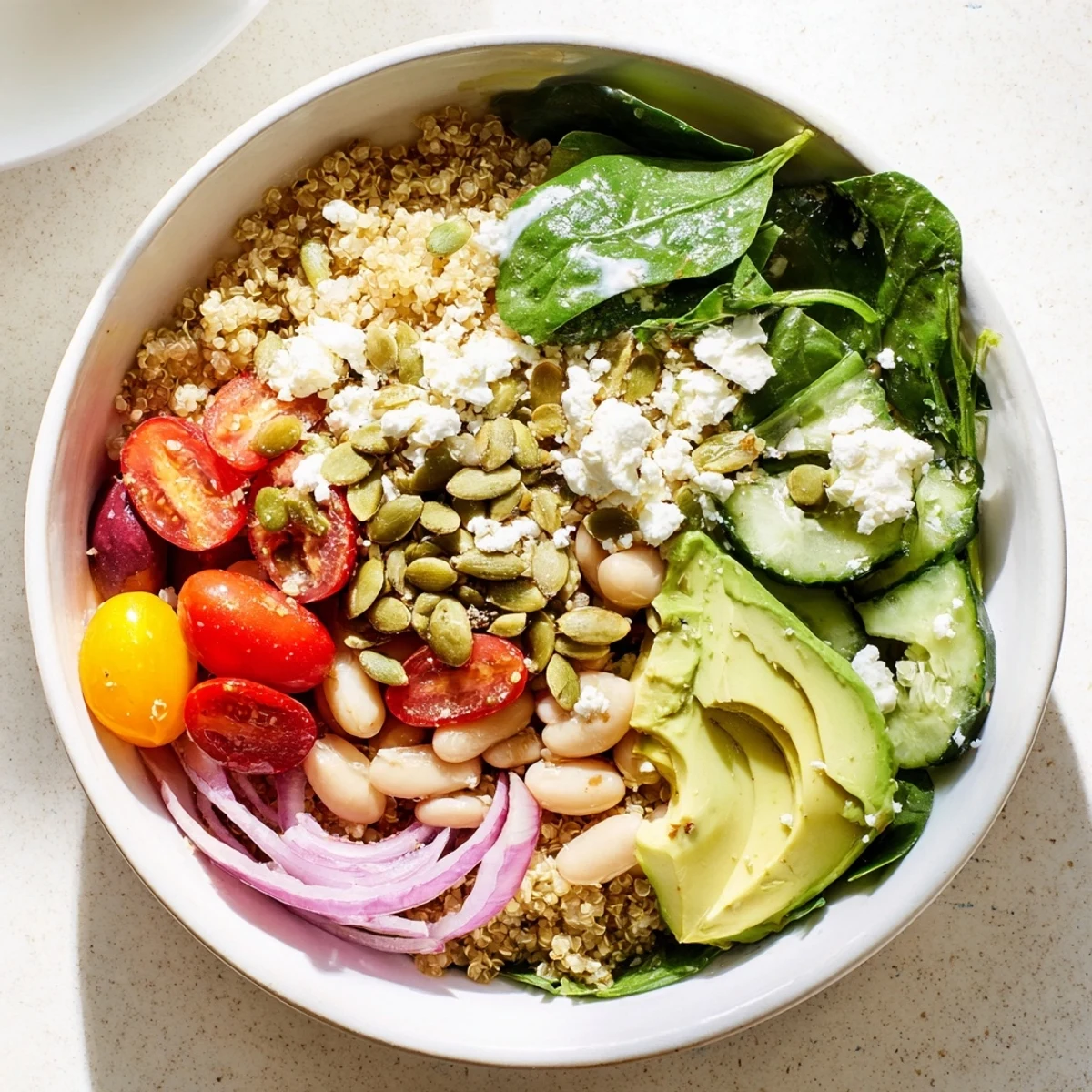 Nourishing Spinach & White Bean Ultimate Protein Power Bowl ready to serve, garnished with feta and sliced red onion for a protein-rich meal.