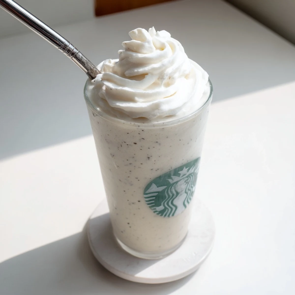 The chilled blended beverage shows smooth ice cream texture and frosty condensation on glass.