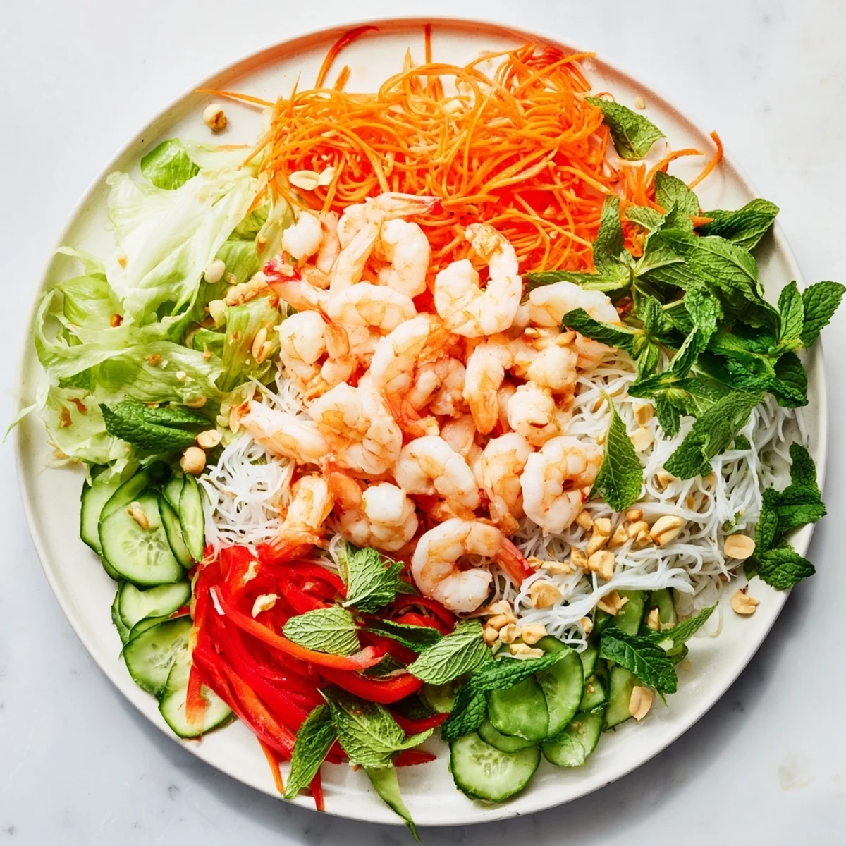 Vibrant Spring Roll Salad bowl with shrimp julienned carrots cucumber and spicy ginger dressing drizzle