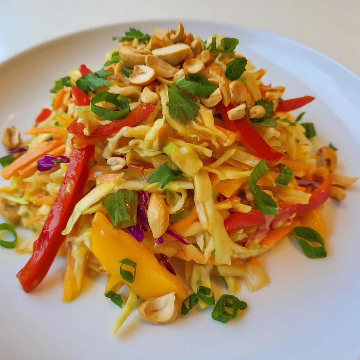 Colorful mango slaw bowl with crunchy red cabbage, carrots, and tangy lime dressing