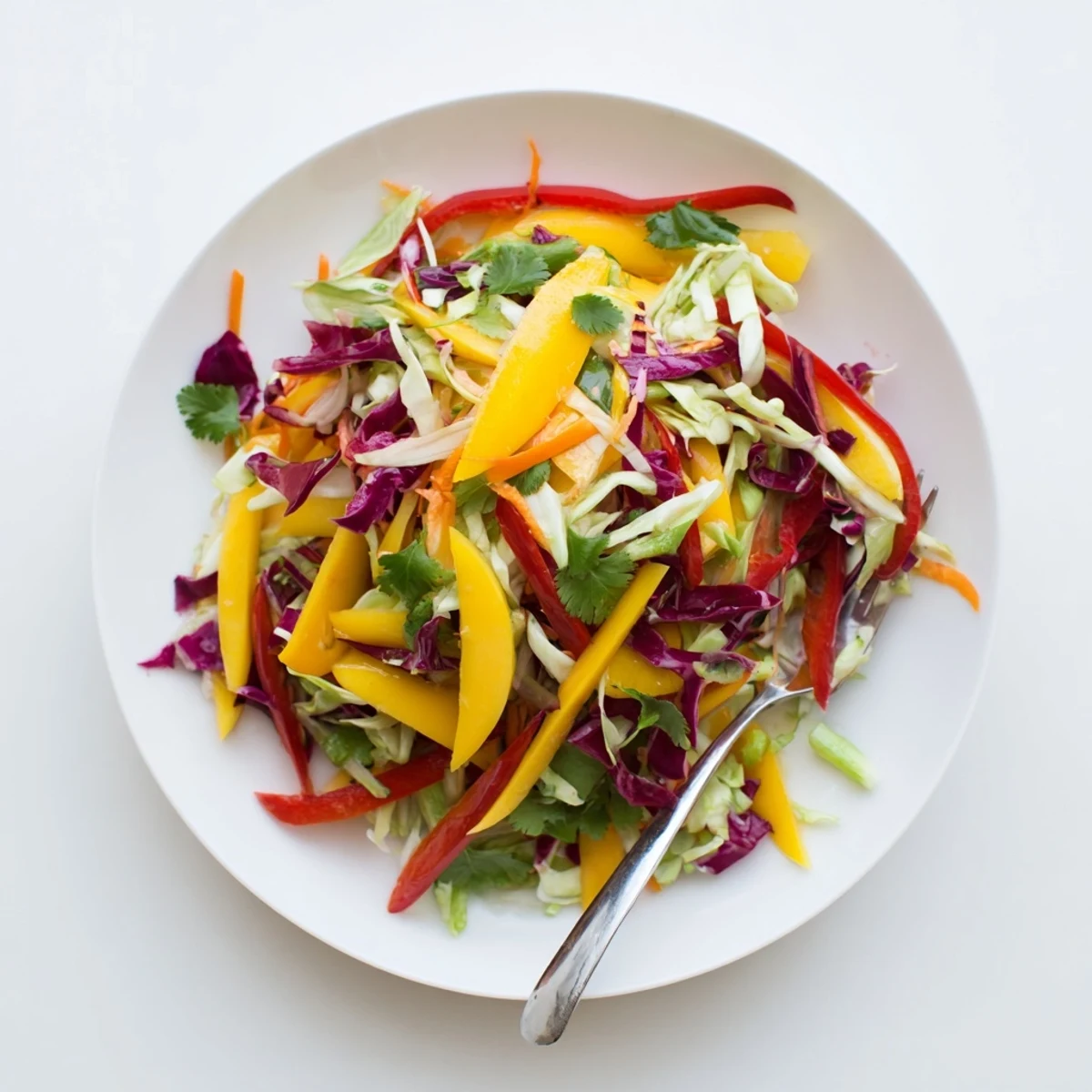 Vibrant mango slaw featuring ripe mango chunks, crisp red and green cabbage tossed in tangy lime dressing
