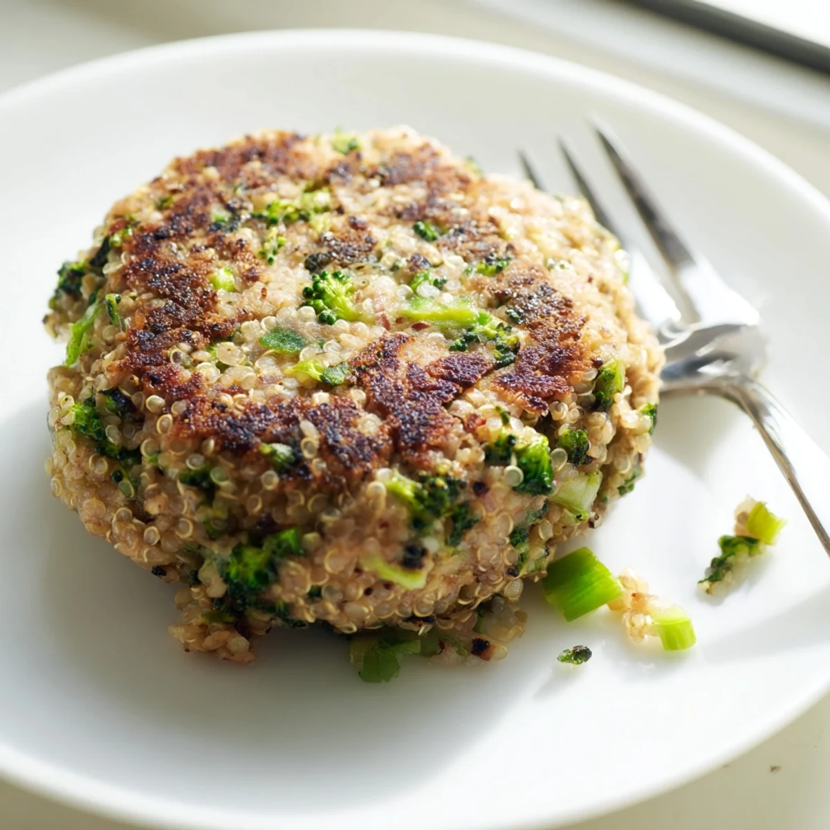 Protein-packed turkey burgers featuring tender quinoa and broccoli pieces on a white plate