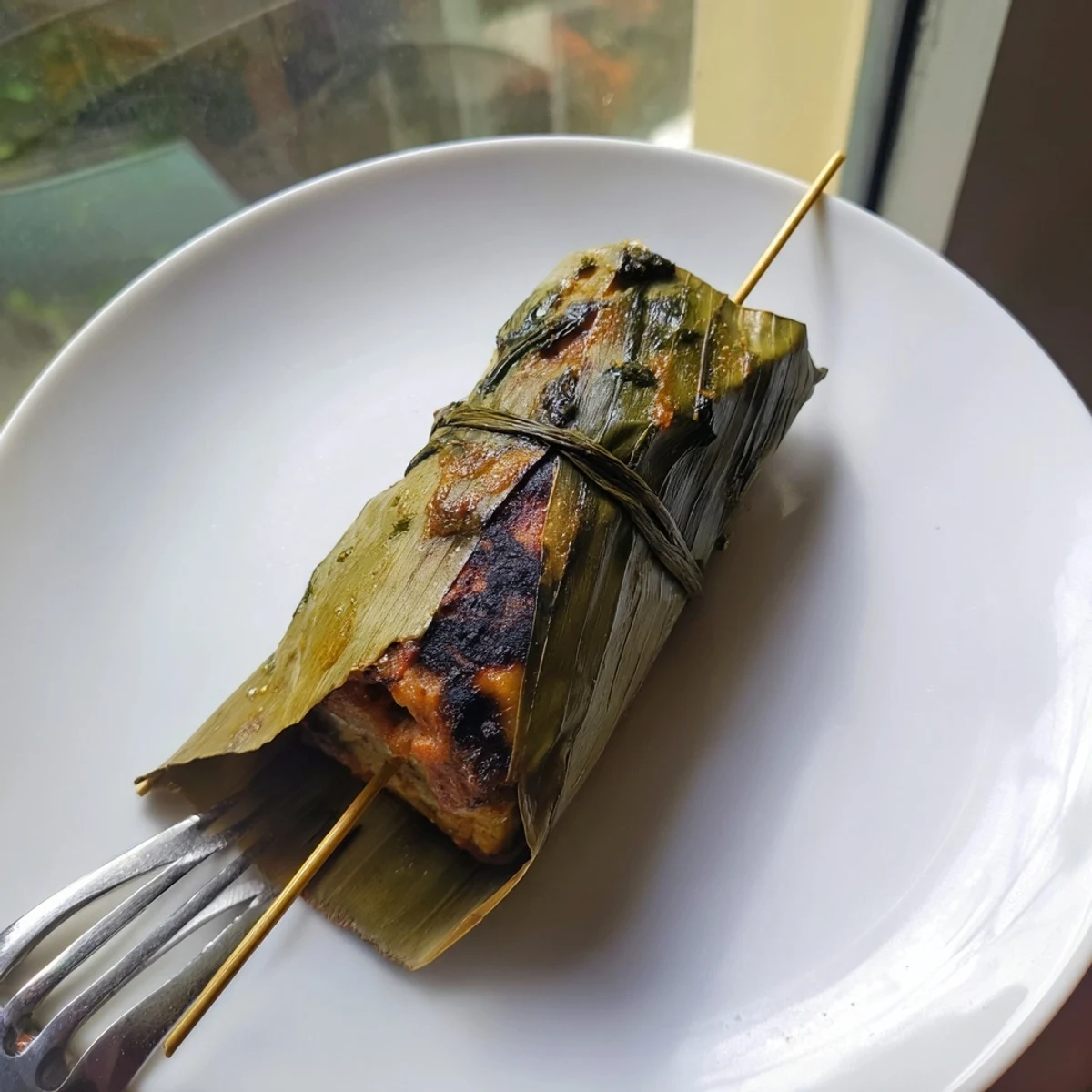 Creamy spiced fish custard in Malaysian Otak Otak grilled to perfection inside green banana leaf packets