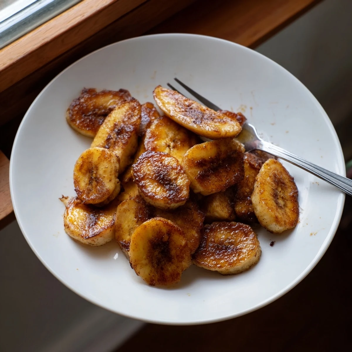 Crispy pan fried cinnamon bananas coated in brown sugar and ground cinnamon